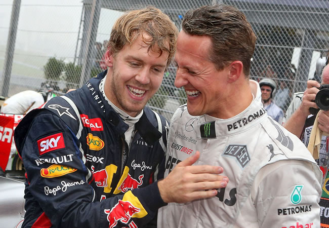 Los pilotos alemanes Sebastian Vettel (i) y Michael Schumacher (d) se saludan en Interlagos. Foto: EFE