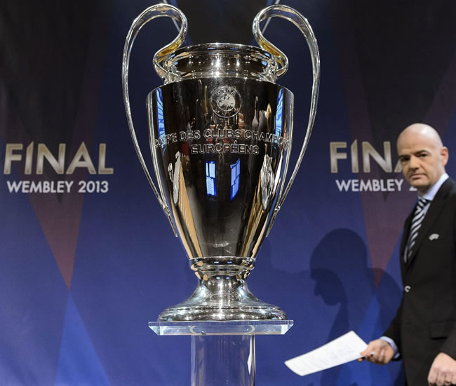 El secretario general de la UEFA, Gianni Infantino, pasa junto al trofeo de la Liga de Campeones. Foto: EFE