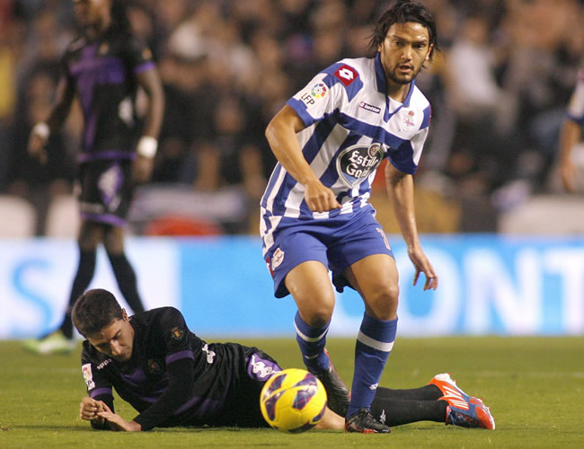 El centrocampista colombiano del Deportivo de La Coruña Abel Aguilar controla el balón ante el centrocampista del Real Valladolid Víctor Pérez (i). Foto: EFE