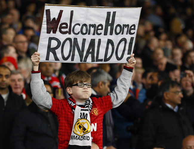 Un niño muestra un cartel en el que se puede leer bienvenido a casa Ronaldo. Foto: EFE
