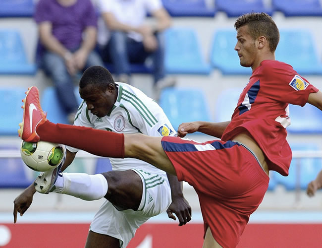 El defensa cubano Kingsley Madu (d) lucha por el control del balón ante el delantero nigeriano Aminu Uma (i). Foto: EFE