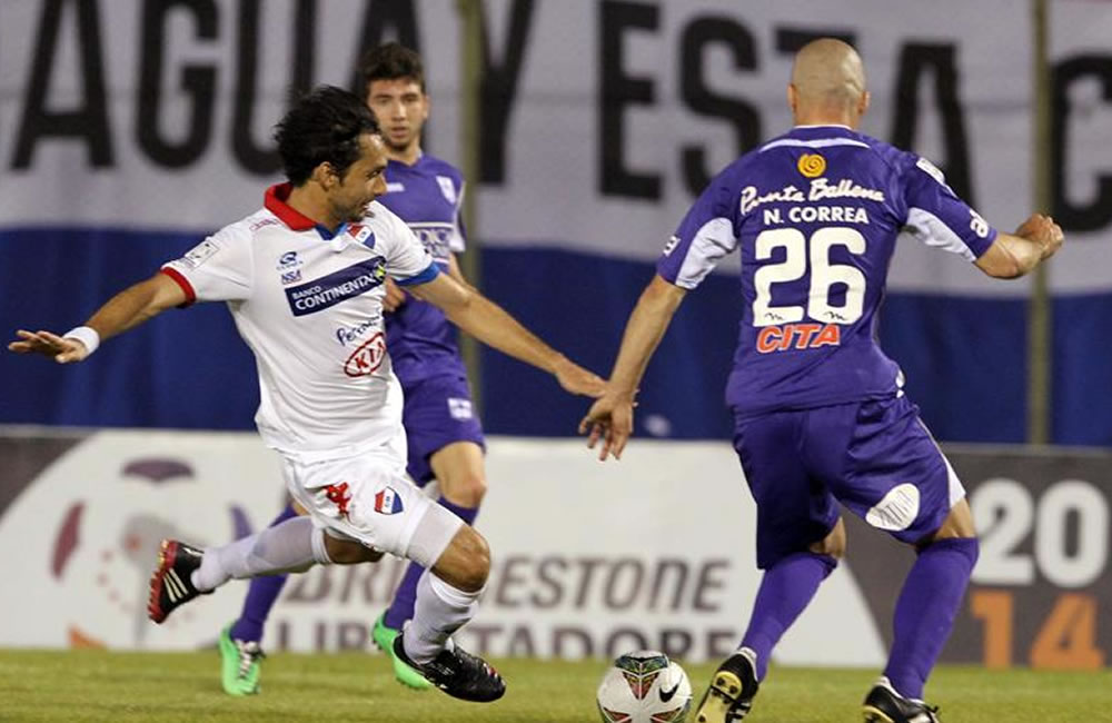 El jugador del Defensor Sporting de Uruguay, Nicolás Correa (d) pelea el balón. Foto: EFE