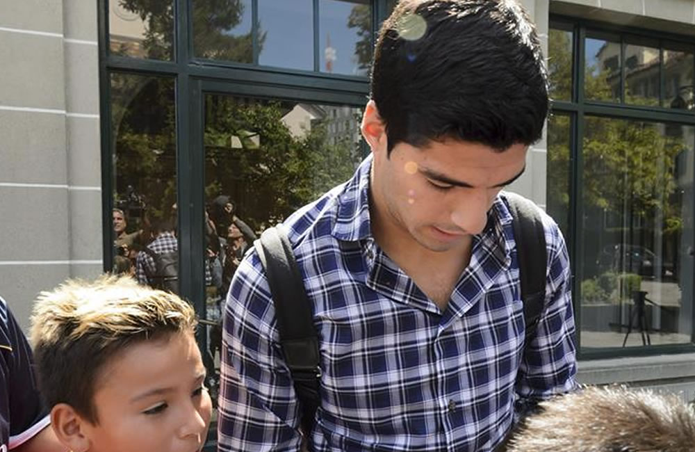 Varios seguidores esperan al futbolista uruguayo Luis Suárez (centro) a su salida del Tribunal de Arbitraje del Deporte (TAS). Foto: EFE