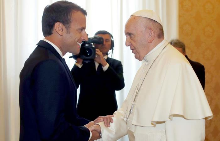 El presidente francés, Emmanuel Macron, (izquiersa) estrecha la mano del papa Francisco antes de una audiencia privada en el Vaticano. Foto: AFP