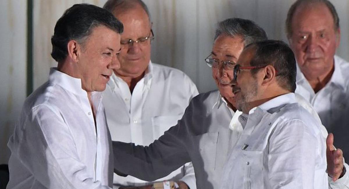 Juan Manuel Santos estrecha las manos de los líderes de las Farc durante los actos de firma de paz con esta agrupación guerrillera. Foto: Twitter @jamerchica